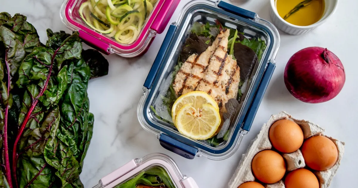 Prepared halal meal prep containers with grilled chicken, rice, and vegetables