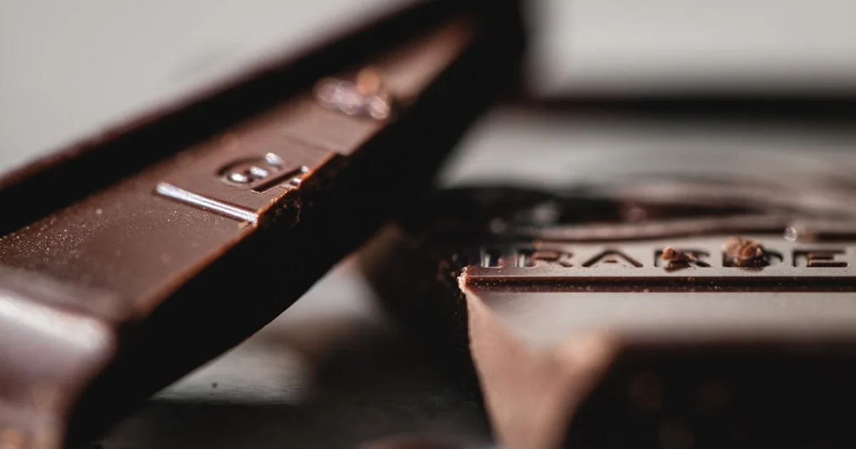 Assorted chocolate bars on a wooden surface