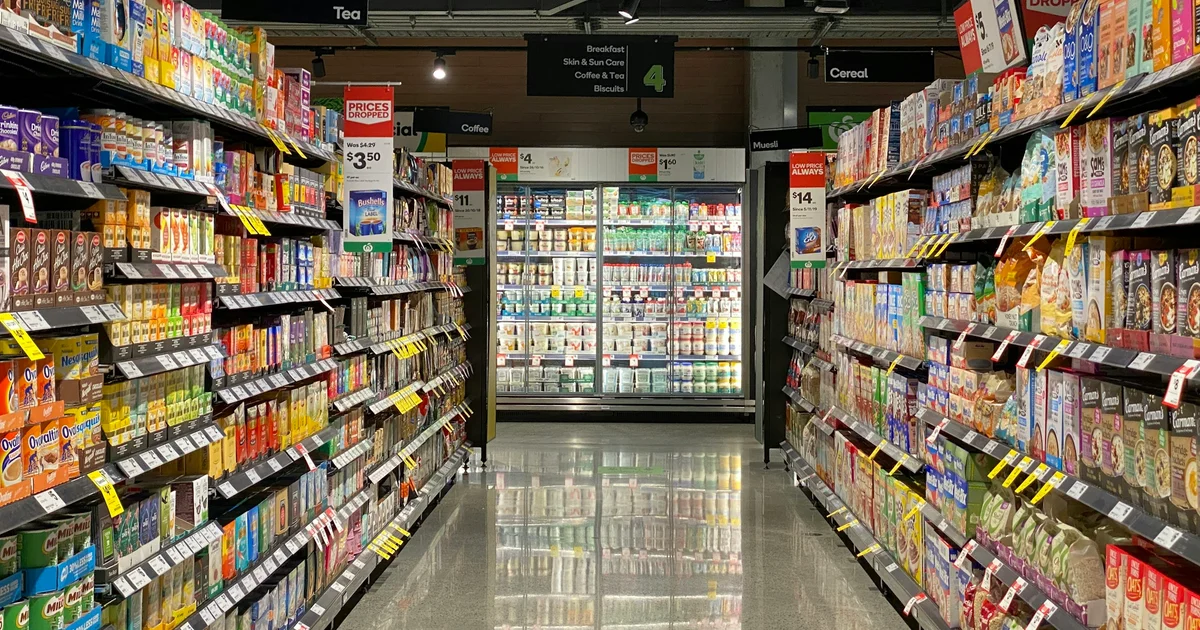 Coles supermarket aisle in Australia with halal certification logos on meat products