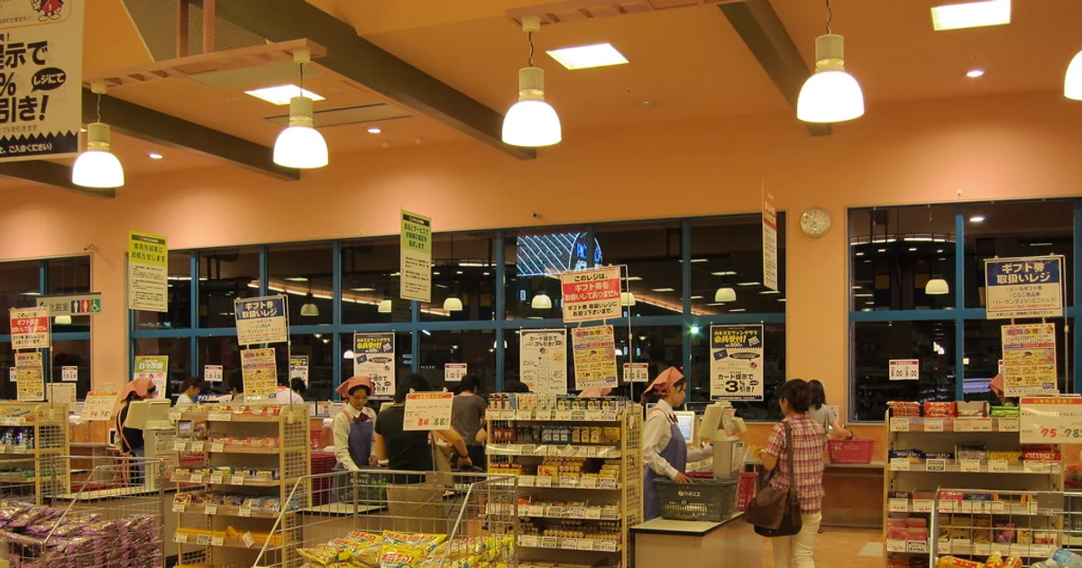 Muslim shopper at Tesco checking food labels for halal verification
