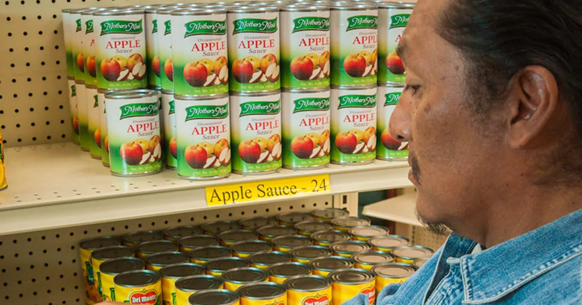 Muslim shopper checking ingredient label in supermarket for halal verification