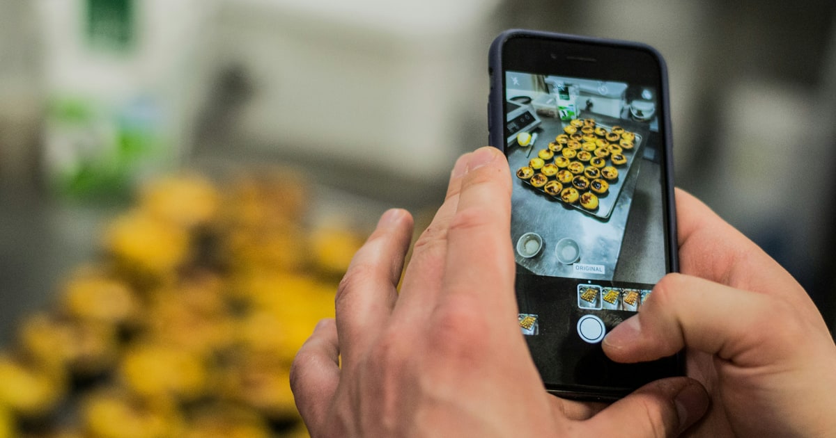 Smartphone camera pointed at a food product label — positioning and lighting are key to a clean scan