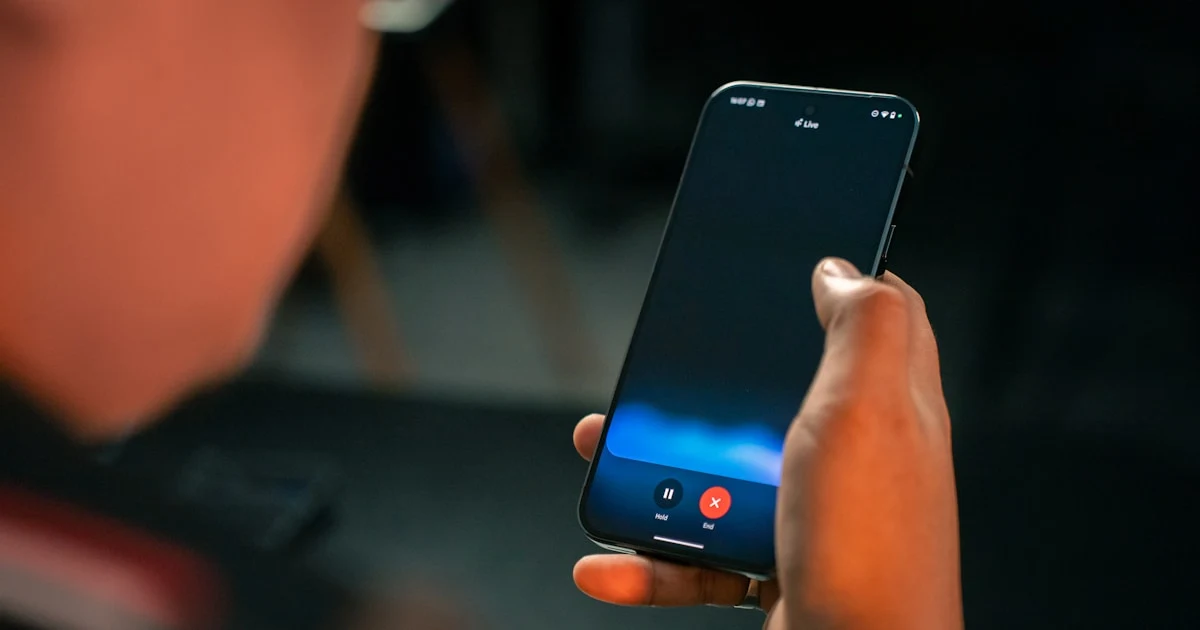 Person speaking into a phone to search for E-codes while holding a food product