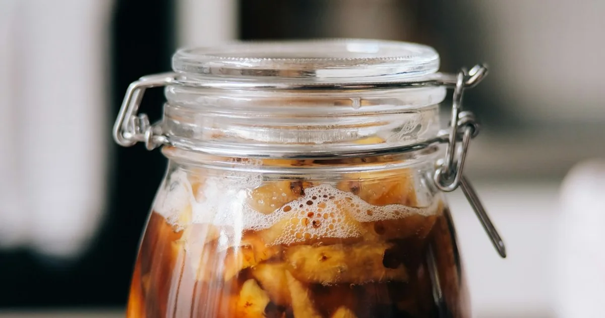 Glass of tepache fermented pineapple drink with pineapple peel — halal guide to the alcohol produced by fermentation
