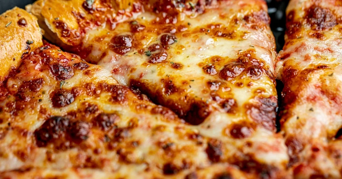Frozen party pizza with triple cheese topping similar to Totino's