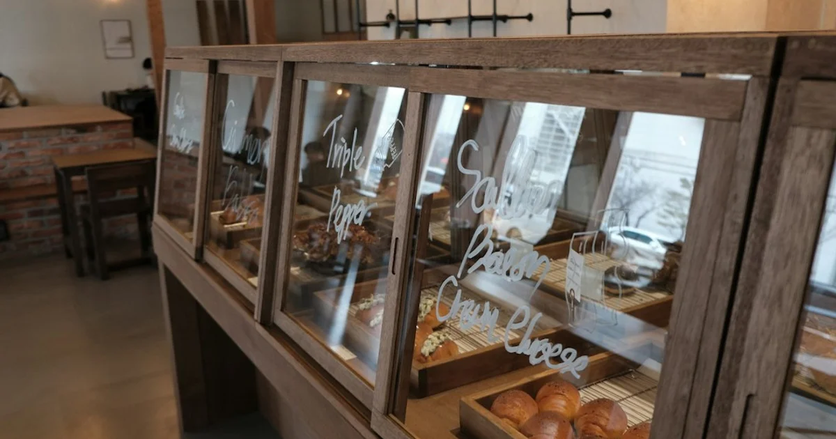 Bakery display of loaves, sandwiches and pastries behind glass — Paris Baguette Singapore's MUIS halal certification